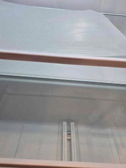Inside of the fridge with clean shelves after cleaning